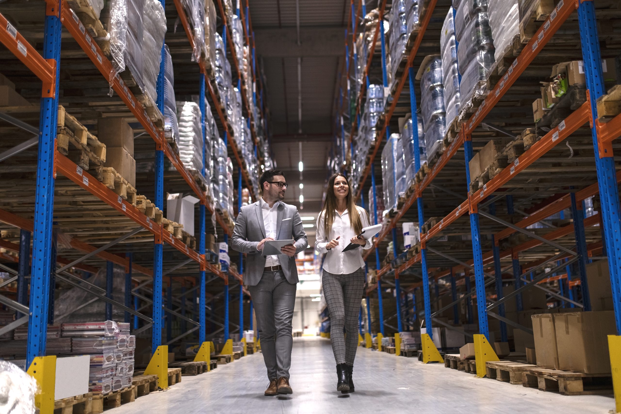 gerentes de armazém - caminhando por um grande centro de distribuição